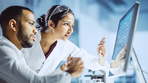 Two scientists looking at a computer screen